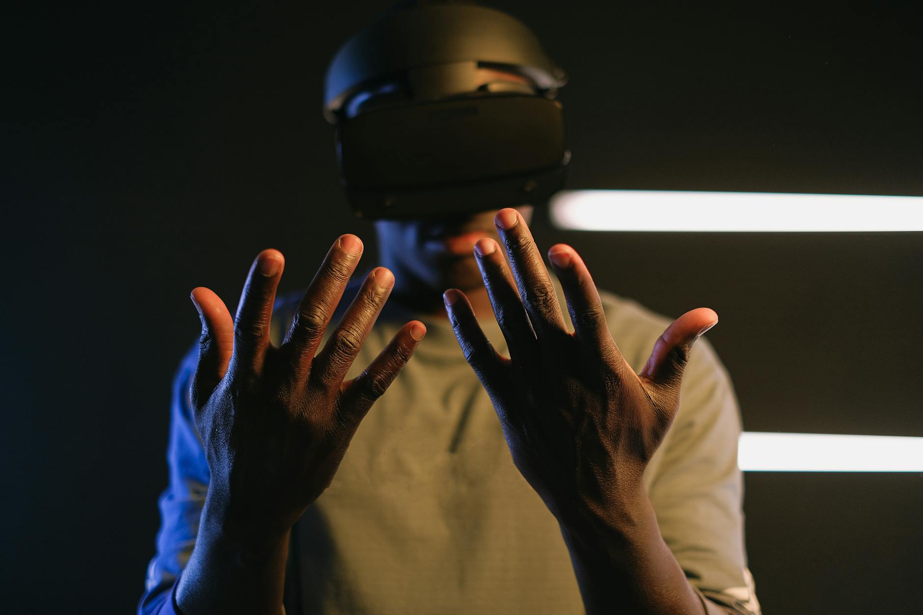 https://www.pexels.com/photo/a-man-looking-at-his-hands-using-a-vr-goggles-7562366/